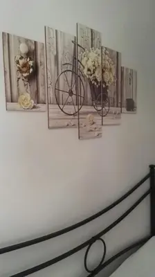 a wall with four pictures and a bike on it at A Casetta Nostra in Rome