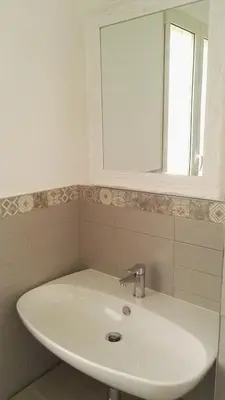 a white sink in a bathroom with a mirror at A Casetta Nostra in Rome