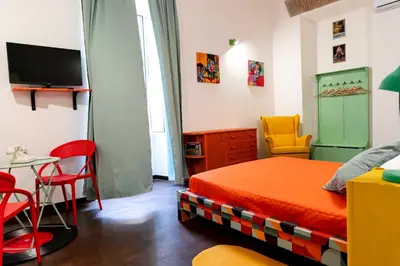 a bedroom with a bed and a table and chairs at ColosseoHome in Rome