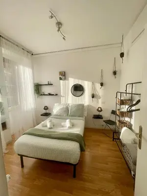 a white bedroom with a bed and a couch at DOMUS I Cozy Apt -20 min from Colosseum in Rome