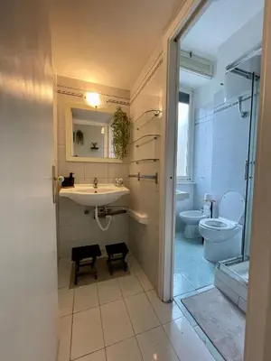 a bathroom with a sink and a toilet at DOMUS I Cozy Apt -20 min from Colosseum in Rome