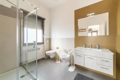 a bathroom with a sink and a toilet and a mirror at B&B Il Giardino di Gabri in Rome