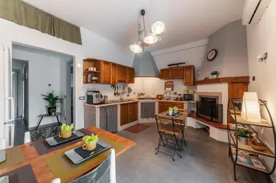 a kitchen and dining room with a table and chairs at B&B Il Giardino di Gabri in Rome