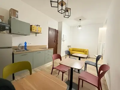 a kitchen with a table and chairs in a room at Nella House Roma in Rome