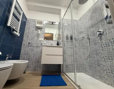 a bathroom with a shower and a sink and a toilet at Nella House Roma in Rome
