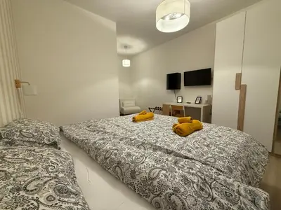 a bedroom with two yellow stuffed animals on a bed at Nella House Roma in Rome