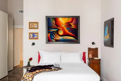 a bedroom with a bed and a painting on the wall at iFlat Timeless Elegance in the Center of Rome in Rome