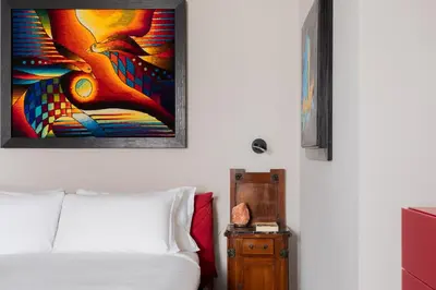 a bedroom with a bed and a painting on the wall at iFlat Timeless Elegance in the Center of Rome in Rome