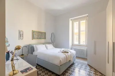 a white bedroom with a bed and a desk at iFlat Timeless Elegance in the Center of Rome in Rome