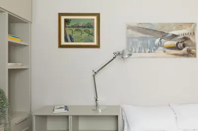 a bedroom with a bed and a desk with a lamp at iFlat Timeless Elegance in the Center of Rome in Rome