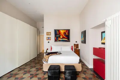 a bedroom with a large white bed and red cabinets at iFlat Timeless Elegance in the Center of Rome in Rome