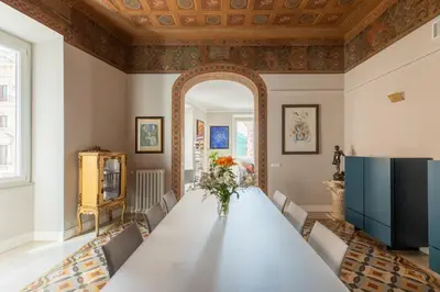 a large dining room with a table and a large mirror at iFlat Timeless Elegance in the Center of Rome in Rome