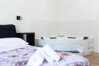 a bedroom with a bed and a bath tub at Termini Roma Imperiale in Rome