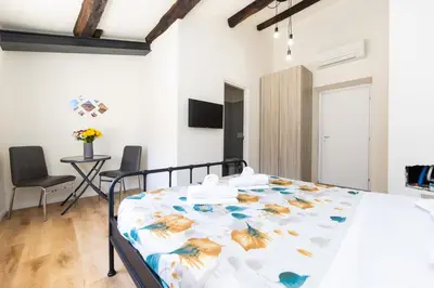 a bedroom with a bed in a room with a table at Termini Roma Imperiale in Rome