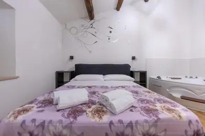 a bedroom with a purple bed with two pillows at Termini Roma Imperiale in Rome