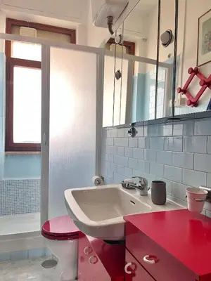 a bathroom with a sink and a toilet and a mirror at Roma San Pietro - Elegante appartamento con vista in Rome