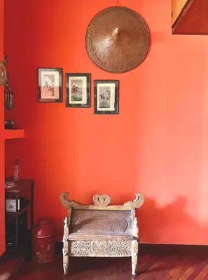 an orange wall with a bench in a room at Roma San Pietro - Elegante appartamento con vista in Rome