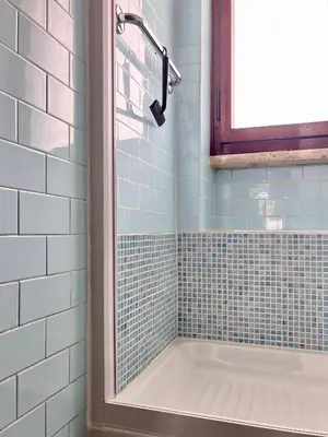 a bathroom with a tub and a window at Roma San Pietro - Elegante appartamento con vista in Rome