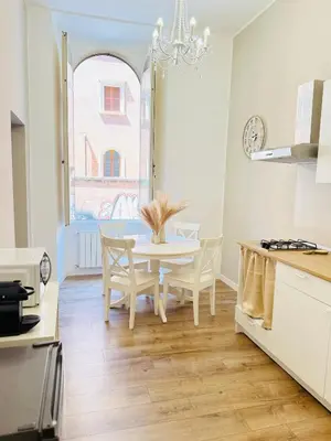 a kitchen with a table and chairs and a window at Seiemme Colosseo Luxury Apartment 2 in Rome