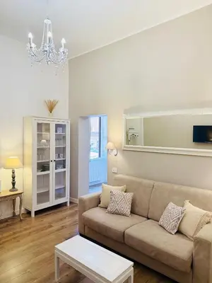 a living room with a couch and a table at Seiemme Colosseo Luxury Apartment 2 in Rome