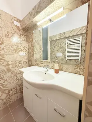 a bathroom with a sink and a mirror at Seiemme Colosseo Luxury Apartment 2 in Rome