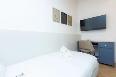 a bedroom with a bed and a desk and a tv at Mellini View by Rental in Rome in Rome