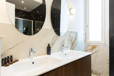 a bathroom with a sink and a mirror at Mellini View by Rental in Rome in Rome