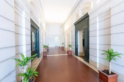 a hallway with potted plants in a building at Mellini View by Rental in Rome in Rome