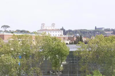 a view of a building with trees in the foreground at Mellini View by Rental in Rome in Rome