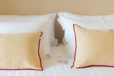 a group of pillows sitting on top of a bed at Mellini View by Rental in Rome in Rome
