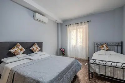 a bedroom with two beds and a window at Star Guest House Rome in Rome