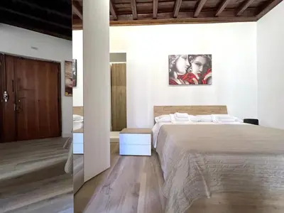 a bedroom with a large bed and a bathroom at Spagna Home in Rome