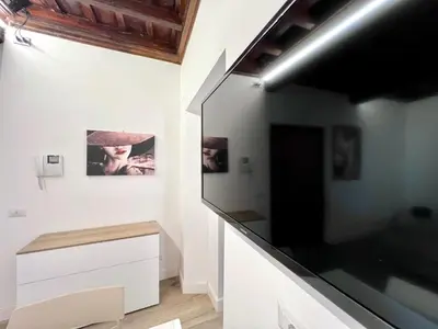 a room with white cabinets and a black wall at Spagna Home in Rome