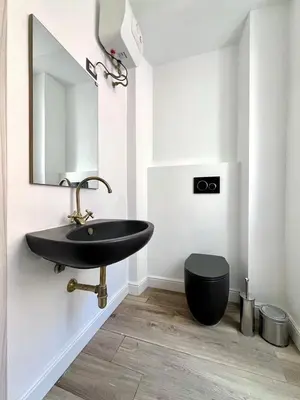 a bathroom with a black sink and a toilet at Spagna Home in Rome