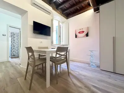 a dining room with a table and chairs at Spagna Home in Rome