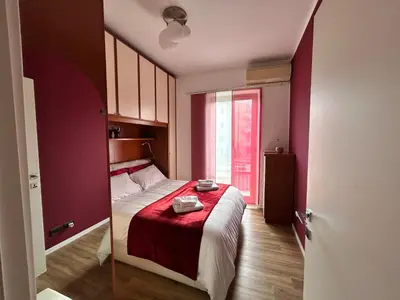 a small bedroom with a bed with a red blanket at Roma San Pietro alloggio turistico Casa Patrizia in Rome