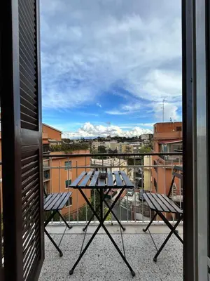 a table on a balcony with a view of a city at Roma San Pietro alloggio turistico Casa Patrizia in Rome