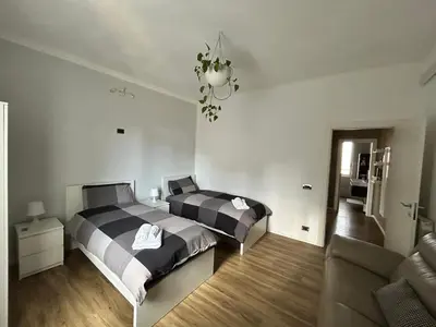 a bedroom with two beds and a couch at Roma San Pietro alloggio turistico Casa Patrizia in Rome