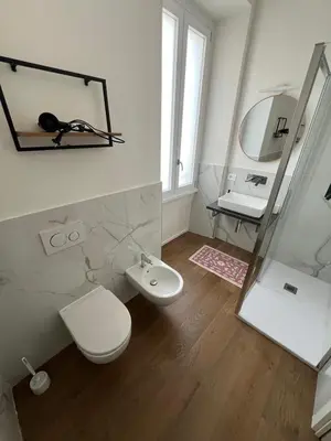 a bathroom with a toilet and a sink and a mirror at Quattro fiori apartment in Rome
