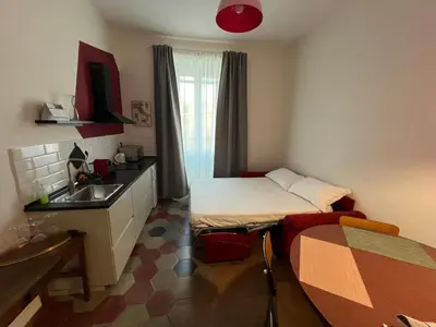 a small room with a bed and a sink at Quattro fiori apartment in Rome