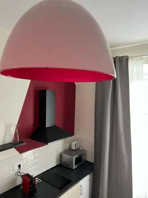a large red light over a kitchen counter at Quattro fiori apartment in Rome