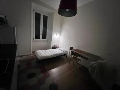 a living room with a white couch and a table at Quattro fiori apartment in Rome
