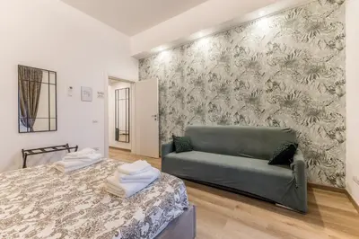 a living room with a couch and a bed at Urbano 29 apartment in Rome