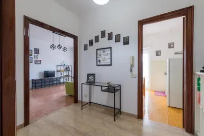 a room with a hallway with a table and a mirror at Katia House in Rome