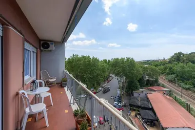 a balcony with a table and a view of a river at Katia House in Rome