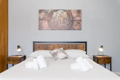 a bedroom with a large white bed with two night stands at Katia House in Rome