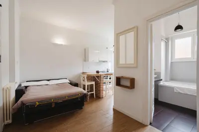 a bedroom with a bed and a table and a window at Maison 46 in Rome