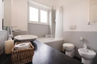 a bathroom with a toilet and a sink at Maison 46 in Rome