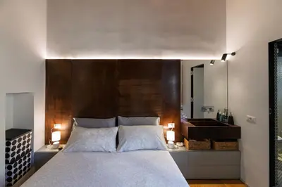 a bedroom with a large bed with a large wooden headboard at Giulia's House, Monti in Rome