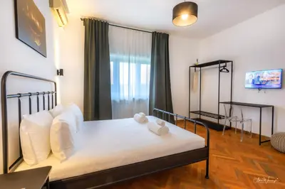 a bedroom with a bed with white sheets and white pillows at Magikrooms Domus in Rome